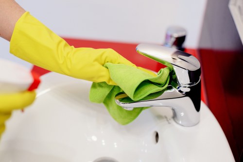 Cleaner using safety equipment during a professional cleaning job in Hammersmith