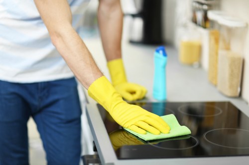 Office cleaning team sanitising desks and shared areas in Hammersmith